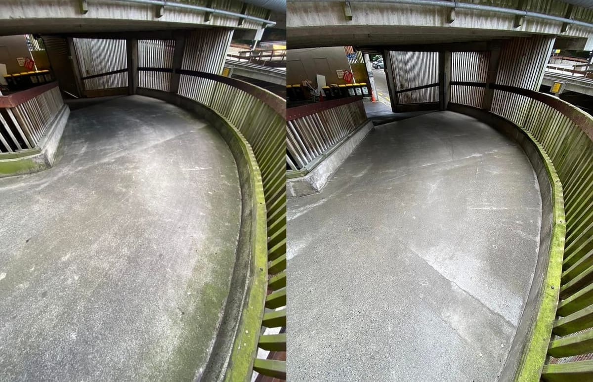 Wellington commercial cleaning at Quest Hotel on The Terrace, curving multi storey carpark ramp with heavy moss along the concrete edge softwashed back, biocide left to keep regrowth at bay.
