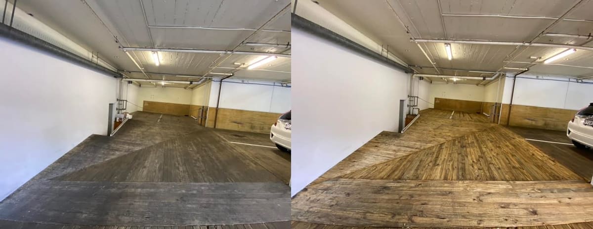 Wellington commercial cleaning at Quest Hotel on The Terrace, large timber decked carpark floor lifted from grey weathered grime to warm honey timber tone after low pressure wash and rinse.