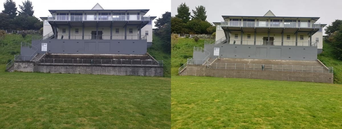 Wellington school exterior cleaning at Newlands College, wide view of the lower field grandstand and concrete seating bank softwashed, lifting black weathering from the front face and treads.